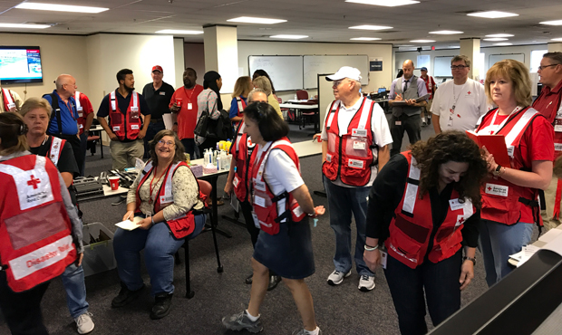 A group of American Red Cross volunteers gather at the Hurricane Harvey operation center in Houston...
