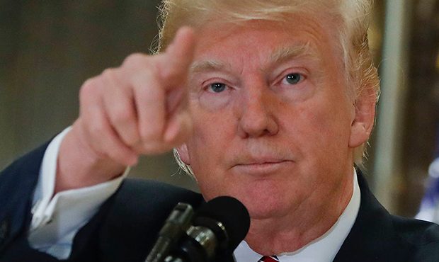 In this Aug. 15, 2017, photo, President Donald Trump points to members of the media as he answers q...