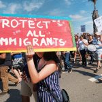 Supporters of the Deferred Action for Childhood Arrivals, or DACA chant slogans and carry signs while joining a Labor Day rally in downtown Los Angeles, Monday, Sept. 4, 2017. (AP Photo/Richard Vogel)