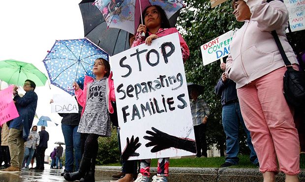 April Soasti, 9, front, and her sister Adriana, 7, stand with other community members after the pre...