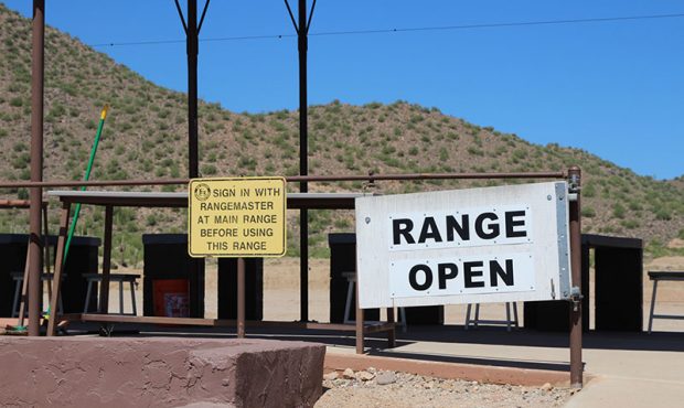 A sign stating that the range at Rio Salado Sportsman’s Club is open lines the rails to one of th...