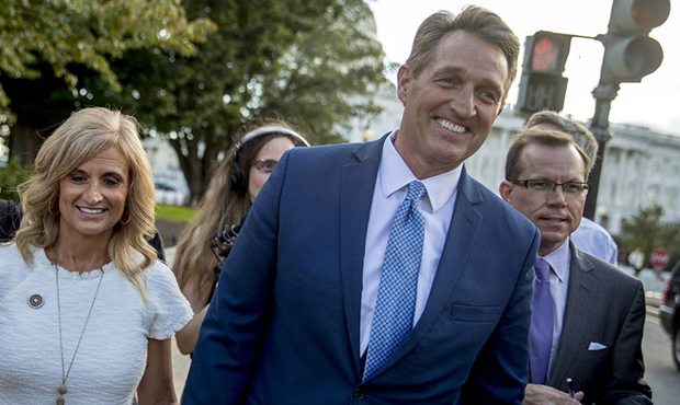Sen. Jeff Flake, R-Ariz., accompanied by his wife Cheryl, leaves the Capitol in Washington, Tuesday...