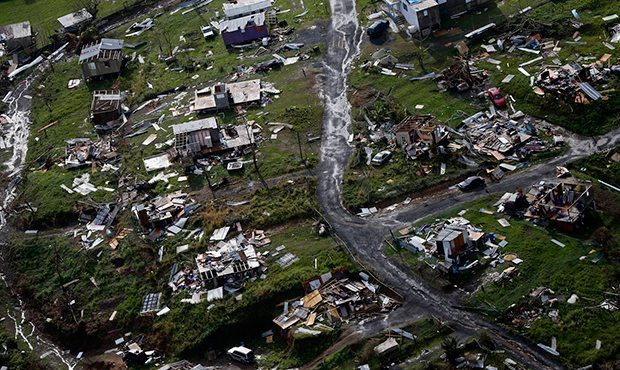 FILE - In this Sept. 28, 2017, file photo, debris scatters a destroyed community in the aftermath o...