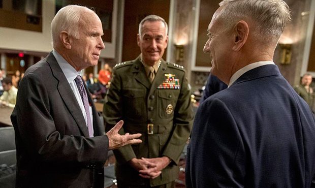 Defense Secretary Jim Mattis, right, and Joint Chiefs Chairman Gen. Joseph Dunford, center, speak w...