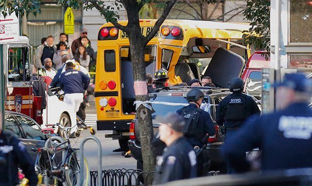 Authorities respond near a damaged school bus Tuesday, Oct. 31, 2017, in New York. A motorist drove...