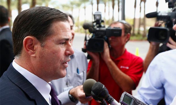 Arizona Republican Gov. Doug Ducey answers a question after a visit to Phoenix Children's Hospital ...