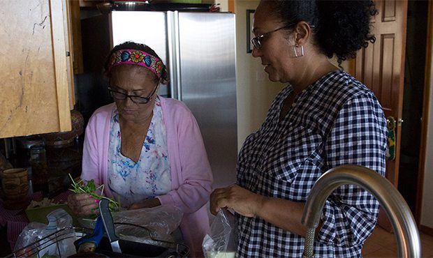Maria Torres and her daughter Maria Cruz-Torres begin preparing the ingredients for ‘Arroz con Po...
