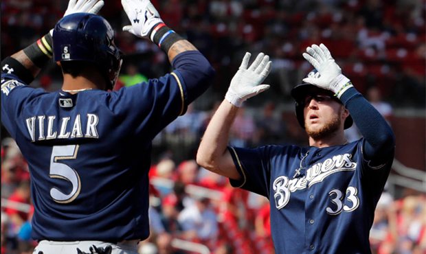 Milwaukee Brewers' Brett Phillips, right, is congratulated by teammate Jonathan Villar after hittin...