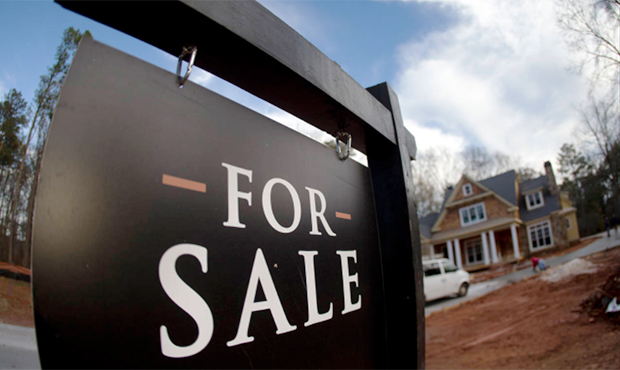 In this Thursday, Dec. 3, 2015, file photo, a home under construction and for sale is shown in Rosw...