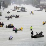 Rescue boats float on a flooded street as people are evacuated from rising floodwaters brought on by Tropical Storm Harvey on Aug. 28, 2017, in Houston. The storm, which later became a hurricane, dumped record rainfall throughout the Houston area. (AP Photo/David J. Phillip)