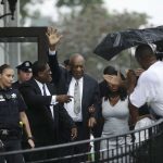Bill Cosby, center, gestures as he leaves the Montgomery County Courthouse in Norristown, Pa., with his publicist Andrew Wyatt, second from left, after a mistrial was declared in his sexual assault trial on June 17, 2017. Cosby's trial ended without a verdict after jurors failed to reach a unanimous decision. (AP Photo/Matt Slocum)
