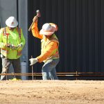 Construction workers hammer stakes in front of the bar and grill garage which will be completed in time for the Spring 2018 race schedule.(Photo by Michelle Minahen/Cronkite News)