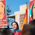 Wenona Benally, member of Arizona House of Representatives, speaks on behalf of the missing and murdered indigenous women at the Women's March in Phoenix. "We wear red in their honor. We must never forget their names and we must never give up seeking justice on their behalf," Benally said. (Photo by Melina Zuniga/Cronkite News)