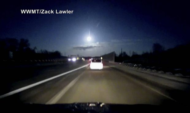 In this late Tuesday, Jan. 16, 2018, image made from dashcam video, a brightly lit object falls fro...