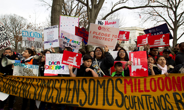 Demonstrators march during an immigration rally in support of the Deferred Action for Childhood Arr...