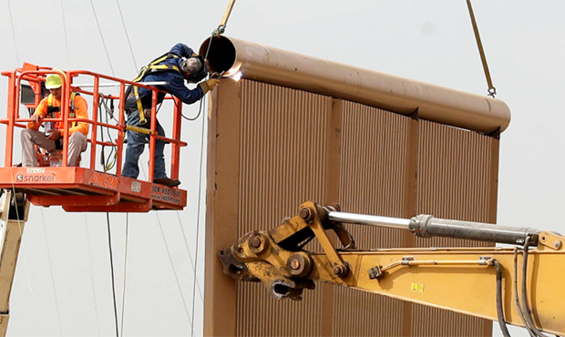 In this Oct. 19, 2017 file photo, crews work on a border wall prototypes near the border with Tijua...