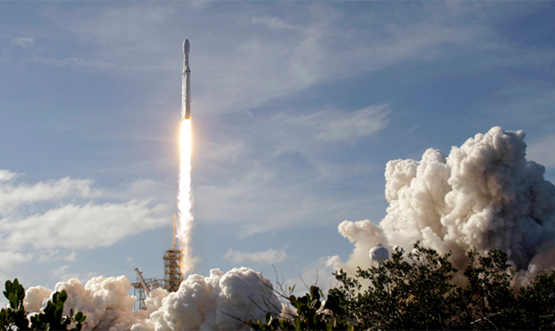 A Falcon 9 SpaceX heavy rocket lifts off from pad 39A at the Kennedy Space Center in Cape Canaveral...