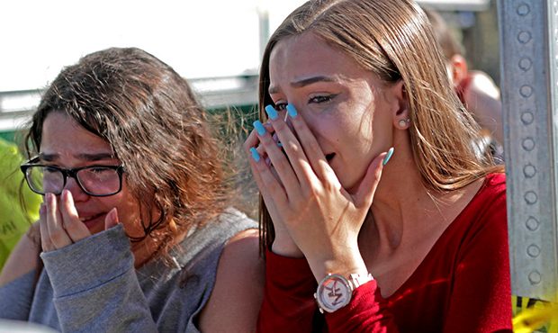 Students released from a lockdown are overcome with emotion following following a shooting at Marjo...