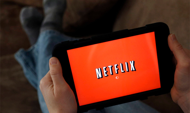 FILE - In this Friday, Jan. 17, 2014, file photo, a person displays Netflix on a tablet in North An...