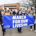 From left, Taylor Green, Elias Addy, and Alex Johnson hold a sign during a "March For Our Lives" rally in Oxford, Miss., Saturday, March 24, 2018. Students and activists across the country planned events Saturday in conjunction with a Washington march spearheaded by teens from Marjory Stoneman Douglas High School in Parkland, Fla., where over a dozen people were killed in February. (Bruce Newman/The Oxford Eagle via AP)