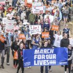 People march during a "March For Our Lives" rally in Oxford, Miss., Saturday, March 24, 2018. Students and activists across the country planned events Saturday in conjunction with a Washington march spearheaded by teens from Marjory Stoneman Douglas High School in Parkland, Fla., where over a dozen people were killed in February. (Bruce Newman/The Oxford Eagle via AP)