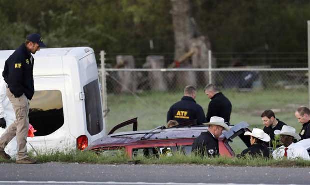 Officials investigate the scene where a suspect in a series of bombing attacks in Austin blew himse...