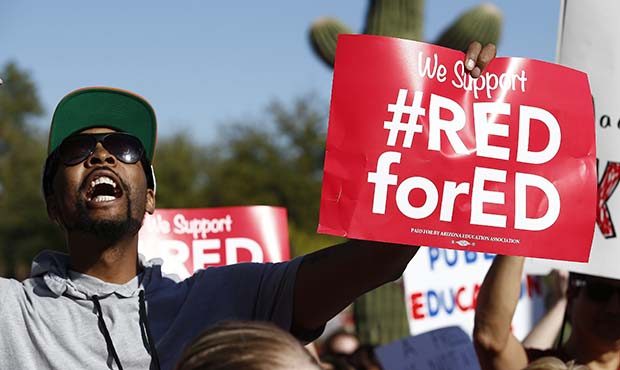 Arizona teachers and education advocates shouts as they march at the Arizona Capitol highlighting l...