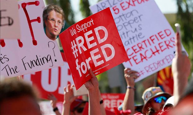 Teachers rally outside the Capitol, Friday, April 27, 2018, in Phoenix, on their second day of walk...