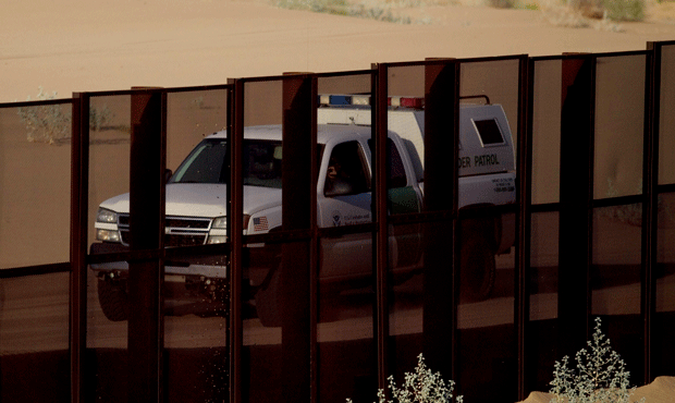 In this July 28, 2010 photo, a US border patrol vehicle drives along the U.S.-Mexico border fence n...
