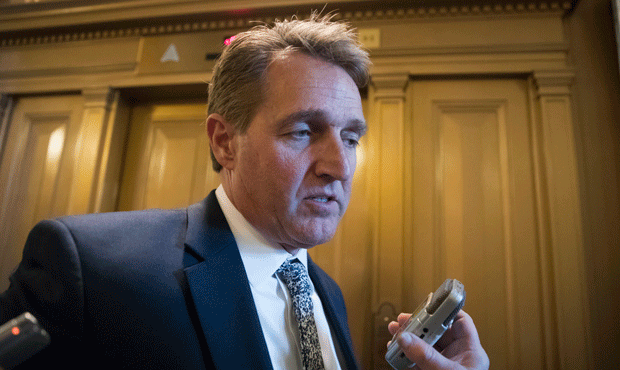 Sen. Jeff Flake, R-Ariz., a frequent critic of President Donald Trump, pauses for reporters followi...
