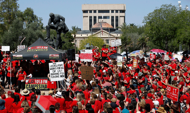 With the Arizona Capitol in the background, thousands of teachers continue to protest Thursday, May...