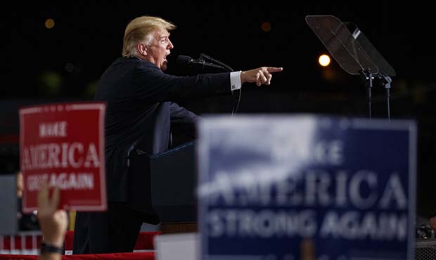 President Donald Trump points as he speaks at a campaign rally at International Air Response, Frida...