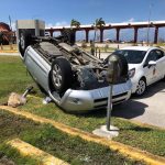 FILE - In this Friday, Oct. 26, 2018, file photo, an overturned car is shown at the airport after Super Typhoon Yutu hit the U.S. Commonwealth of the Northern Mariana Islands in Garapan, Saipan. Elections are being postponed in a Pacific U.S. territory going without electricity after a super typhoon destroyed homes, toppled trees, utility poles and left a woman dead. (AP Photo/Dean Sensui, File)