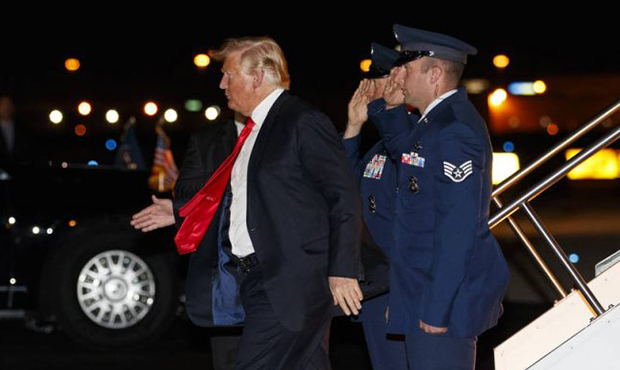 President Donald Trump walks to his motorcade vehicle as he arrives on Air Force One at Phoenix Sky...