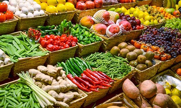 Fruit market with various colorful fresh fruits and vegetables (DepositPhotos)...