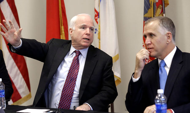Sen. John McCain, R-Ariz., makes a comment as North Carolina Senate candidate Thom Tillis, right, l...