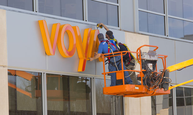 Workers install a sign on the Voya Financial building in Windsor, Connecticut. (Voya Financial Phot...