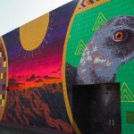 This 76-foot by 22-foot mural in Yuma honors the Sonoran pronghorn and the Yuma clapper rail, a marsh bird, is the twentieth in a series commissioned by the Center for Biological Diversity. Both species live along the Arizona-Mexico border. (Photo by Oskar Agredano/Cronkite News)