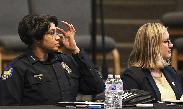 Phoenix Police Chief Jeri Williams, left, and Mayor Kate Gallego, right, listen to a speaker at a c...