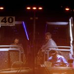 Edward and Jane Jacobucci rest on a bus after leaving Christmas Hill Park following a deadly shooting at the Gilroy Garlic Festival, in Gilroy, Calif., on Sunday, July 28, 2019. The couple, who were manning a booth selling garlic graters, said they took shelter behind their stand as a gunman opened fire in from of them. (AP Photo/Noah Berger)