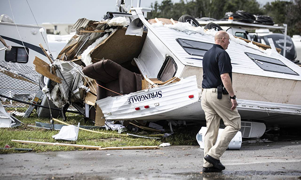 Bill Bailey, assistant chief of the Emerald Isle Police Department, walks past a damaged trailer in...