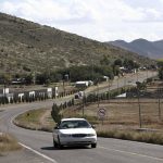 A car passes through Colonia LeBaron, one of many locations where the extended LeBaron family lives in the Galeana municipality of Chihuahua state in northern Mexico, Tuesday, Nov. 5, 2019. Drug cartel gunmen ambushed on Monday three vehicles along a road near the state border of Chihuahua and Sonora, slaughtering at least six children and three women from the extended LeBaron family, all of them U.S. citizens living in northern Mexico, authorities said Tuesday. (AP Photo/Christian Chavez)