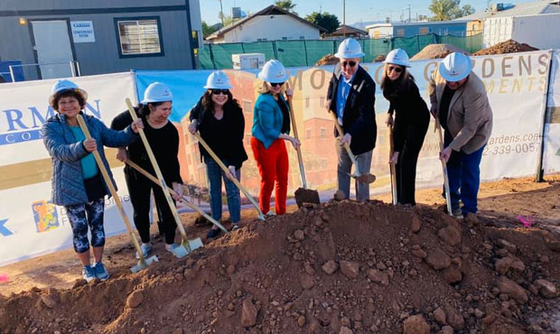 Mayor Kate Gallego (red pants) takes part in a groundbreaking ceremony for the Monroe Gardens Apart...