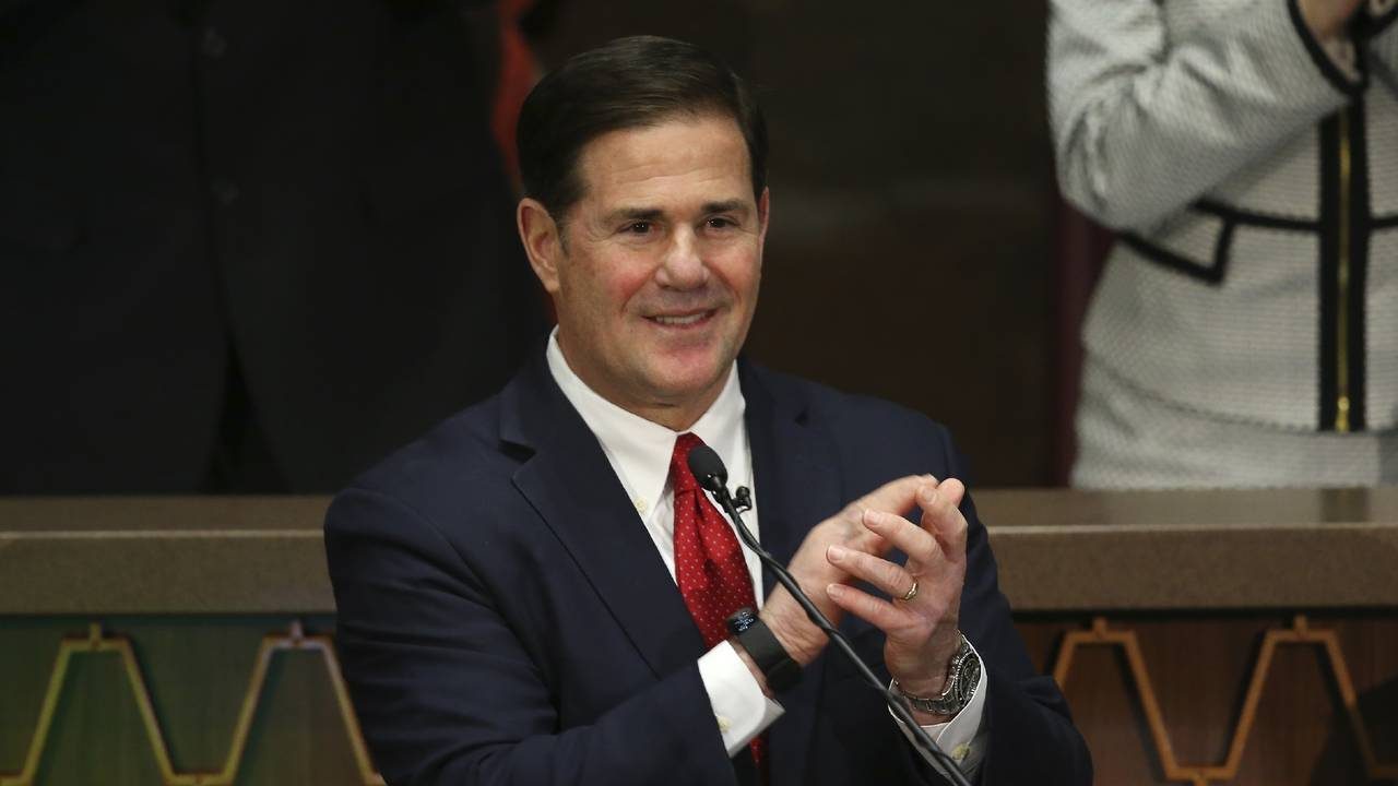 Arizona Republican Gov. Doug Ducey applauds first responders during his State of the State address ...