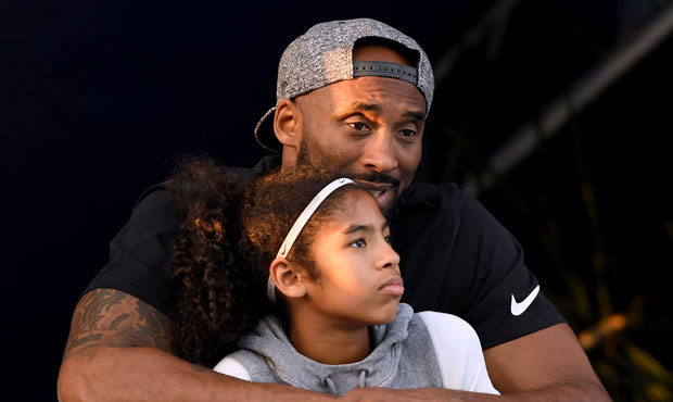 Kobe Bryant and daughter Gianna Bryant watch during day 2 of the Phillips 66 National Swimming Cham...