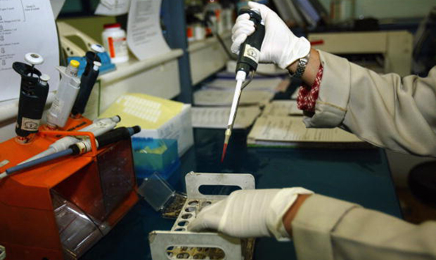 Tri Lailatul, a lab technician at the Dharmais hospital in Jakarta, Indonesia, does a CD4 AIDS test...