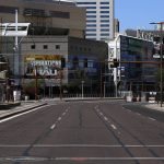 An empty street is devoid of vehicular traffic and pedestrians due to the coronavirus Sunday, March 29, 2020, in Phoenix. (AP Photo/Ross D. Franklin)