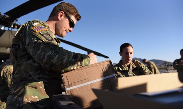 Arizona National Guard personnel prepare boxes of personal protective equipment for transport to Ch...