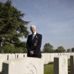 
              British RAF veteran George Sutherland, 98, poses for a photo at Lijssenthoek war cemetery prior to taking part in a VE Day charity walk to raise funds for Talbot House in Poperinge, Belgium, Friday, May 8, 2020. Sutherland segment walked from the Lijssenthoek war cemetery to Talbot house to raise money for the club which is currently closed due to coronavirus lockdown regulations. The club, founded in 1915 was a place for British soldiers to rest during both the First and Second World Wars. (AP Photo/Virginia Mayo)
            