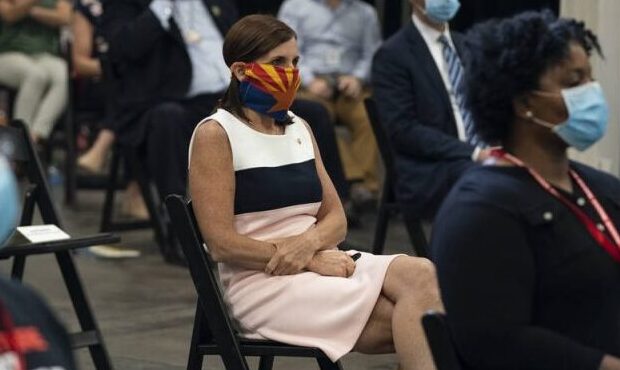 Sen. Martha McSally, R-Ariz., wears an Arizona flag mask as she listens to President Donald Trump s...